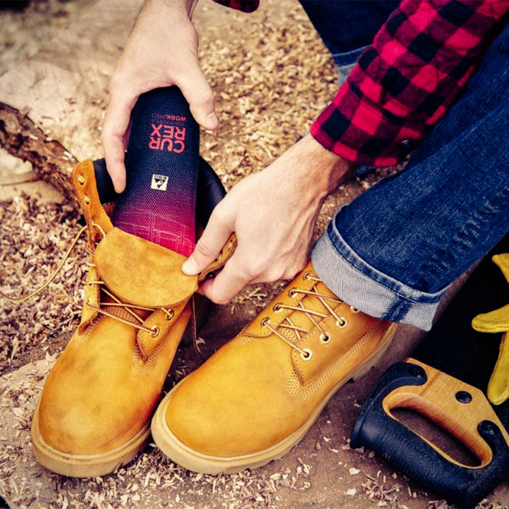 Man placing CURREX WORK low-profile red insole into work boot #1-wahl-dein-profile_low